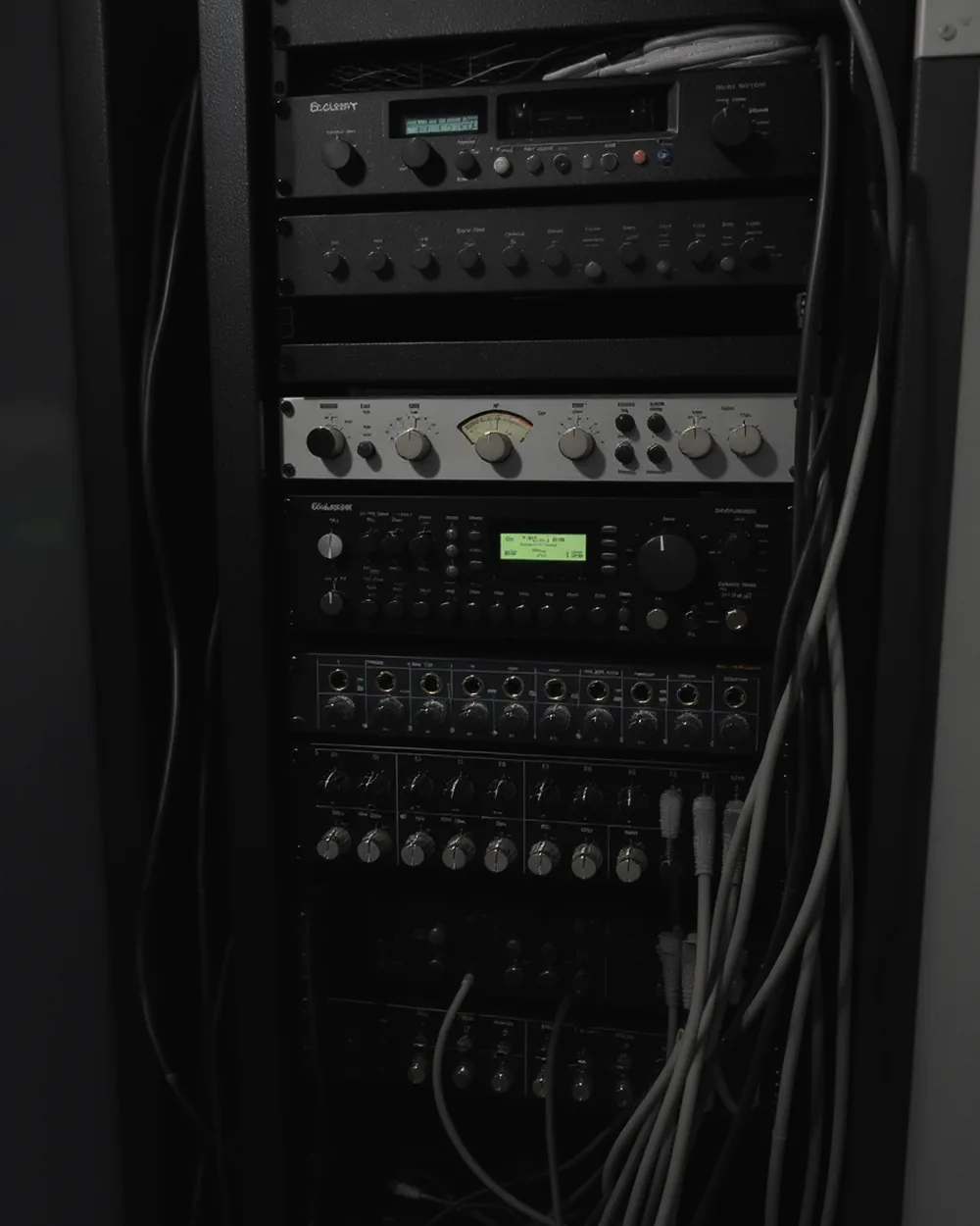 Equipment rack with preamps, VU meters, a half-rack interface and a patchbay.
